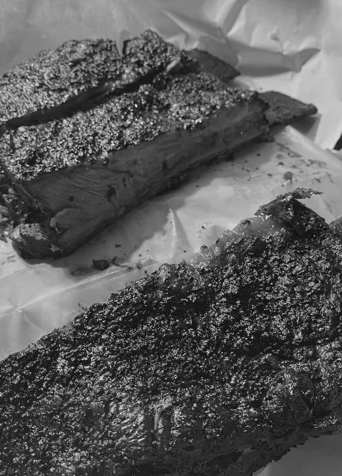 Smoked ribs resting on butcher paper