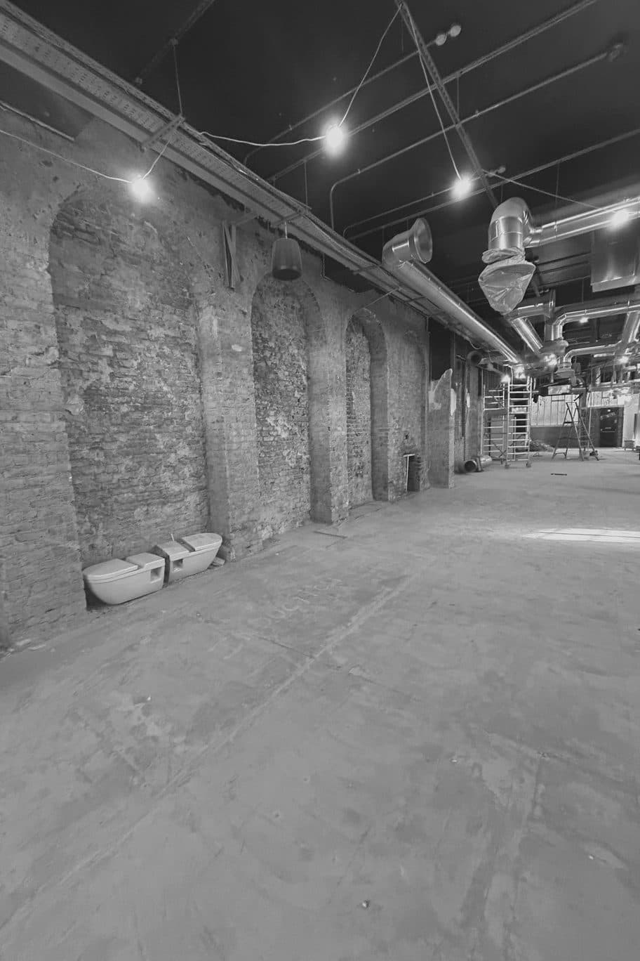 The room in progress, brick arches along the wall