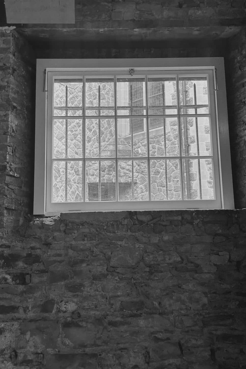 A window set deep in the stone wall